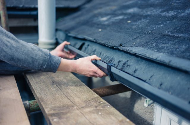 Salem Gutter Worker Fixing Drain filled with water